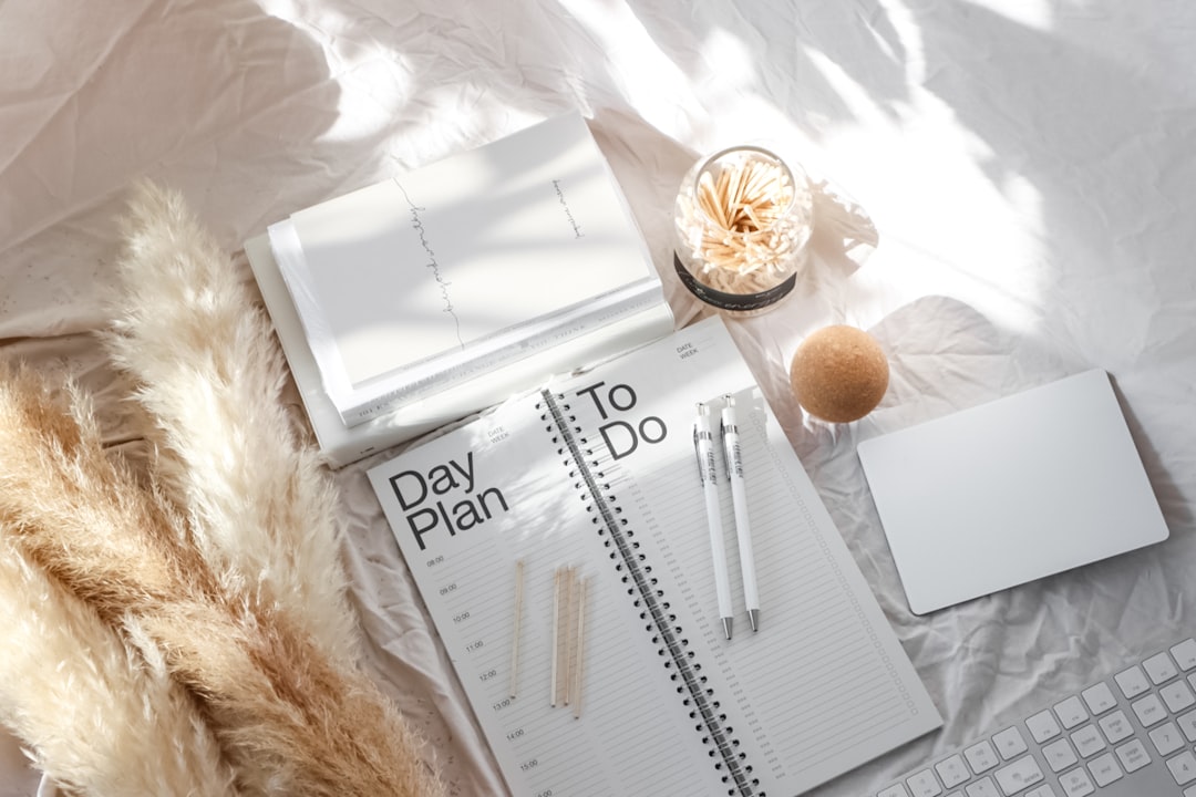 White stationery flat lay with planner and notebook